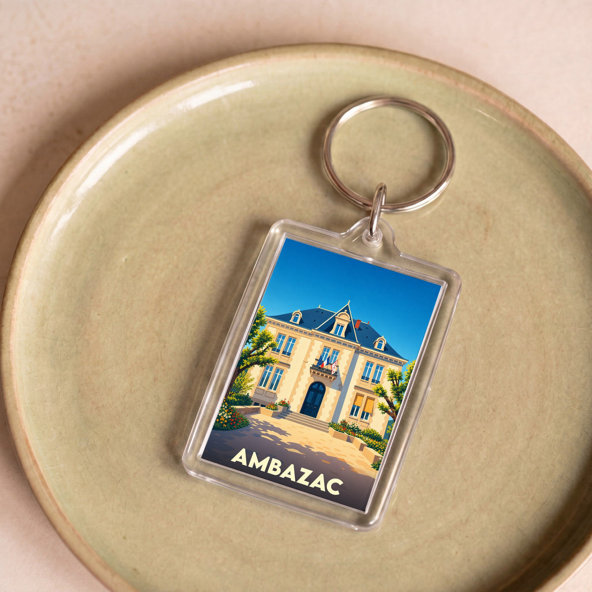 Porte-clés souvenir de la ville d'Ambazac avec une illustration stylisée de sa mairie.