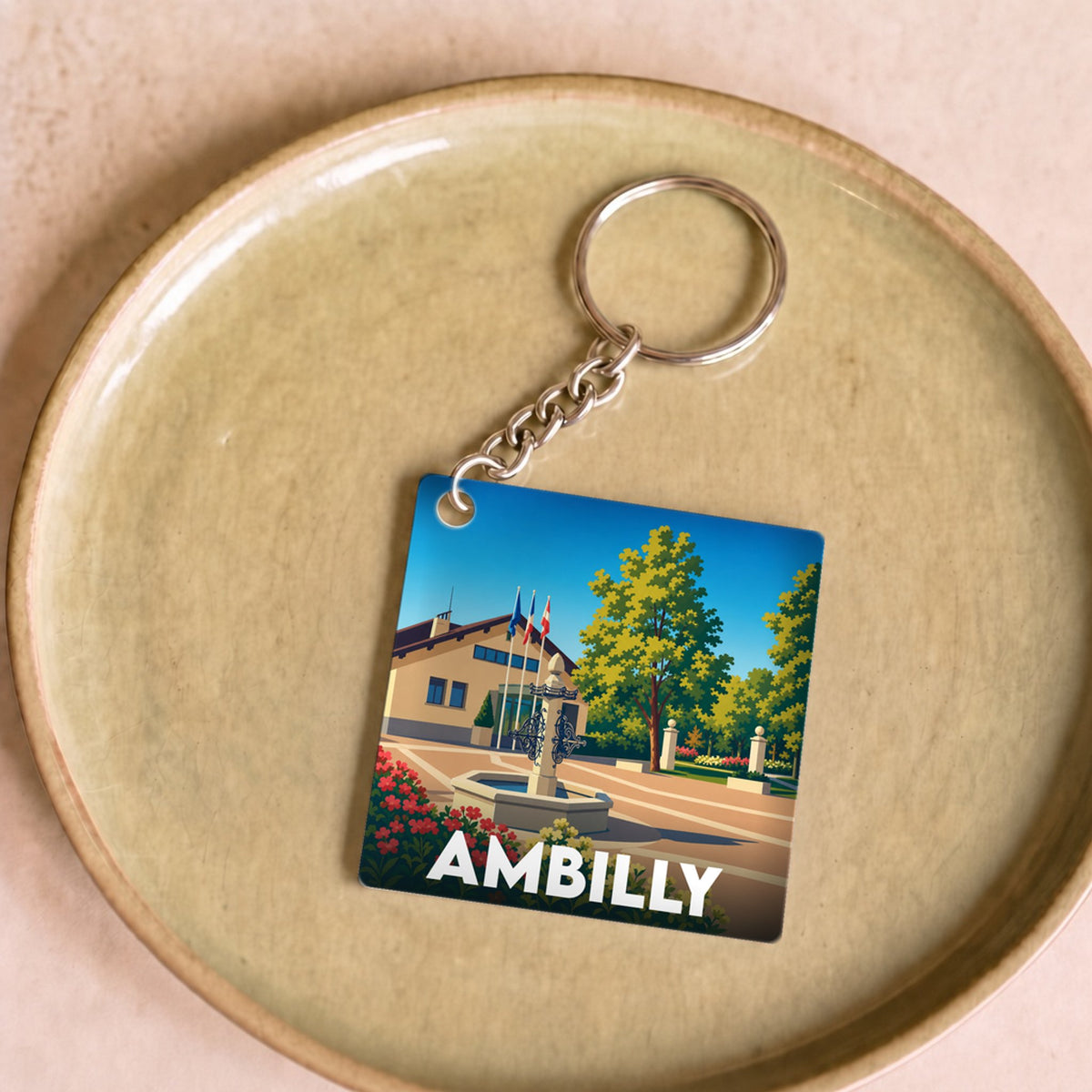 Porte-clés souvenir de la ville d'Ambilly avec une illustration stylisée.