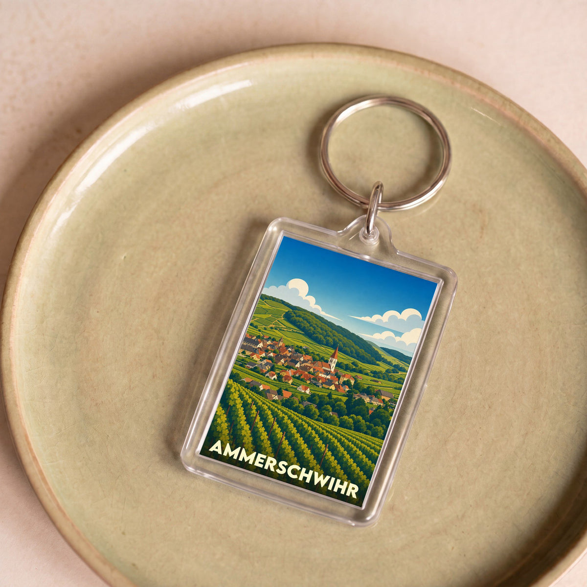 Porte-clés souvenir de la ville de Ammerschwihr avec une illustration stylisée de son vignoble.