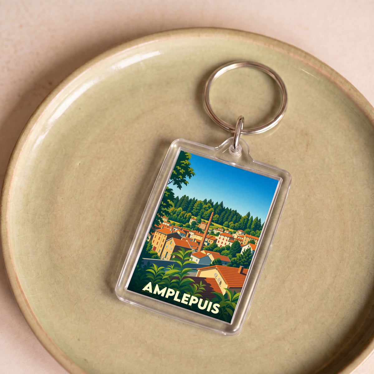 Porte-clés souvenir de la ville d'Amplepuis avec une illustration stylisée.