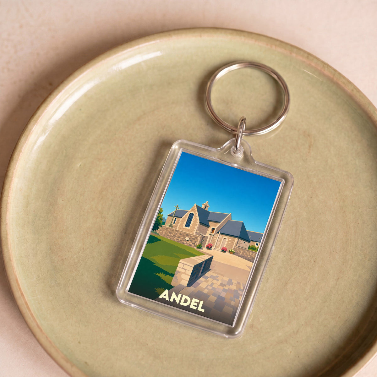 Porte-clés souvenir de la ville d'Andel avec une illustration stylisée de son église.