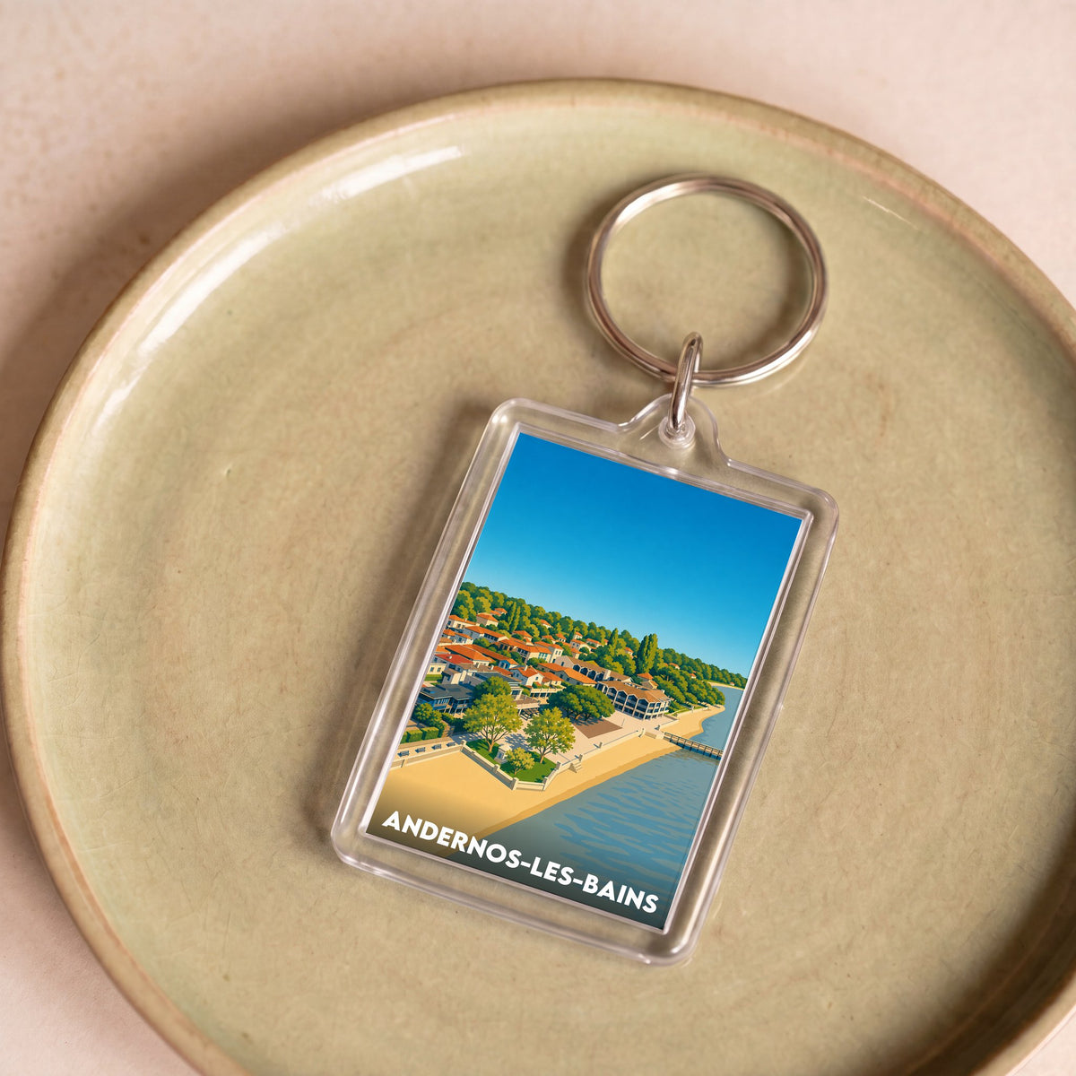 Porte-clés souvenir de la ville d'Andernos-les-Bains avec une illustration stylisée.