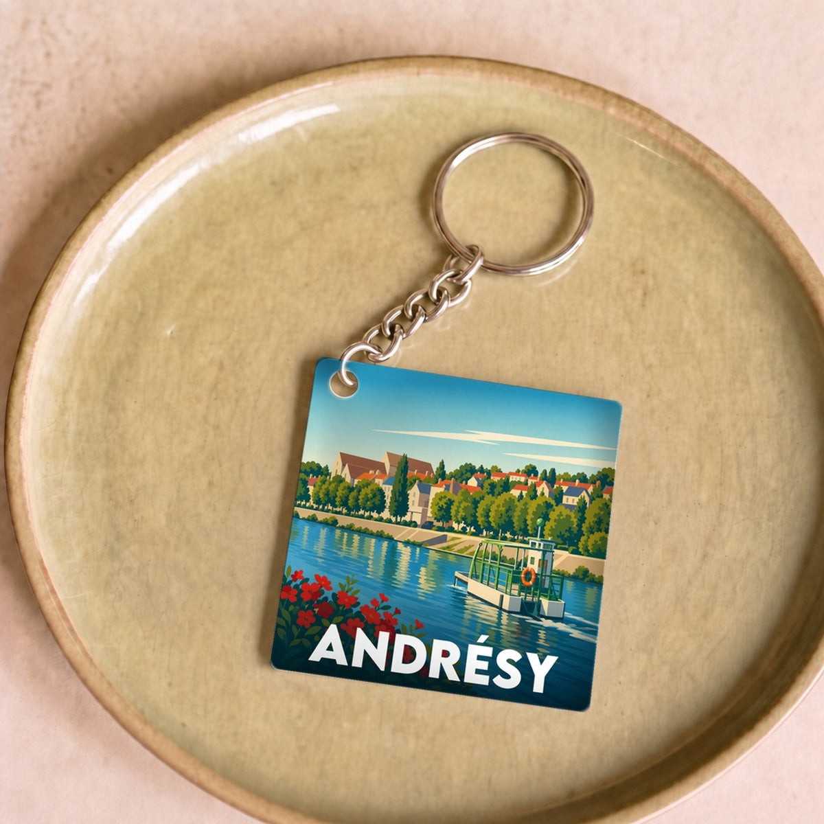 Porte-clés souvenir de la ville d'Andrésy avec une illustration stylisée.