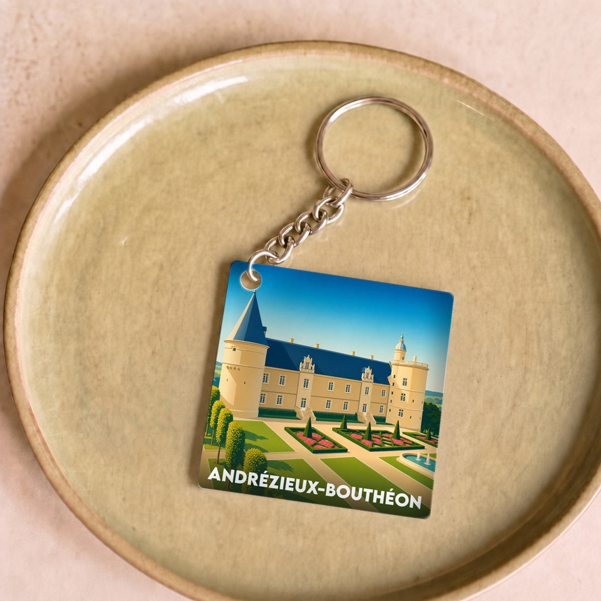 Porte-clés souvenir de la ville de Andrézieux-Bouthéon avec une illustration stylisée de son château.