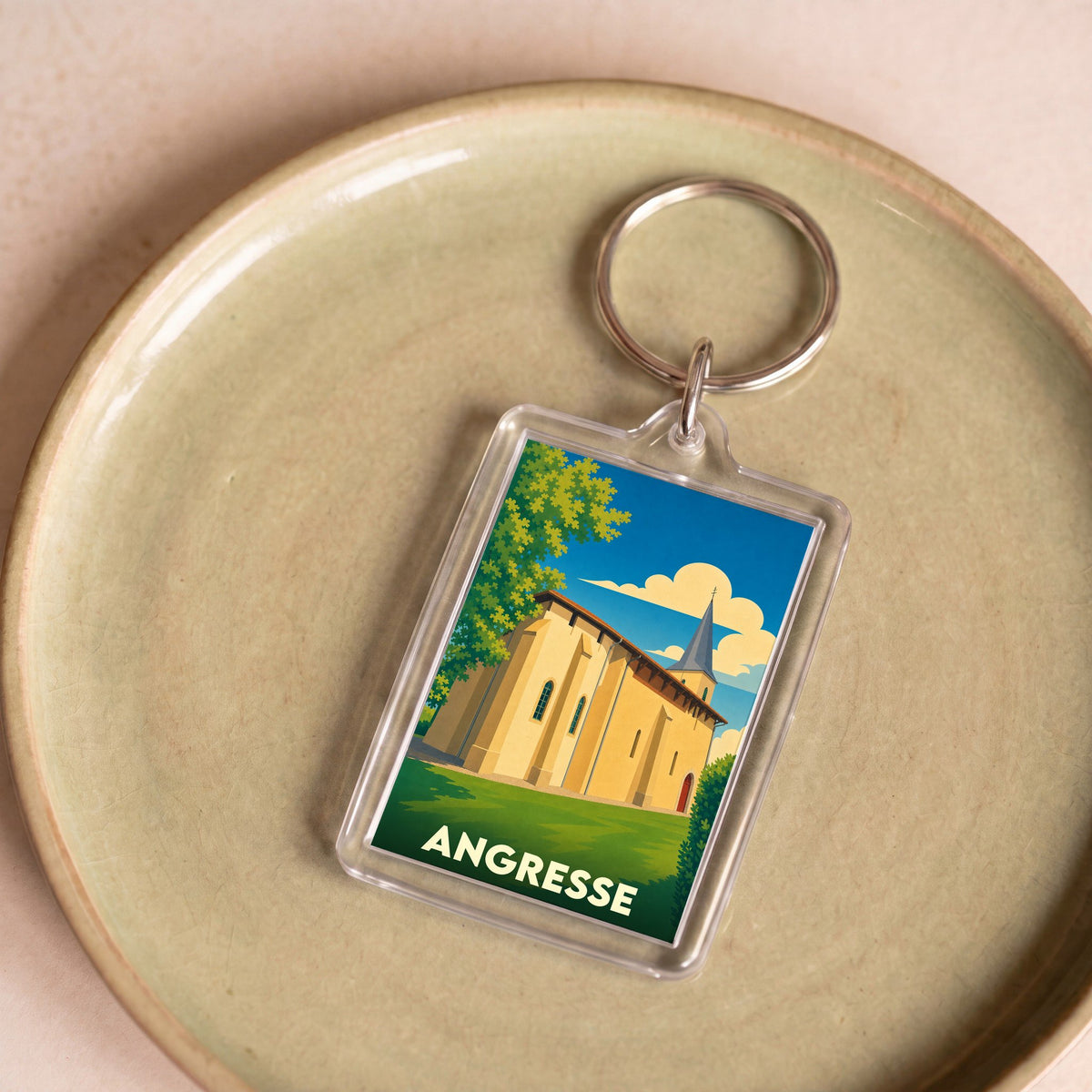 Porte-clés souvenir de la ville d'Angresse avec une illustration stylisée de son église.