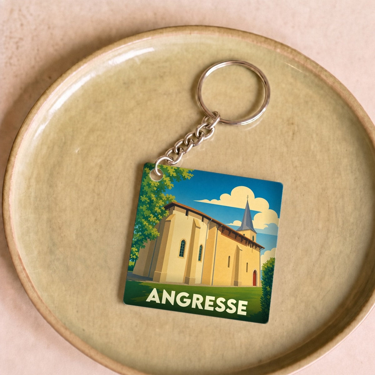 Porte-clés souvenir de la ville d'Angresse avec une illustration stylisée de son église.
