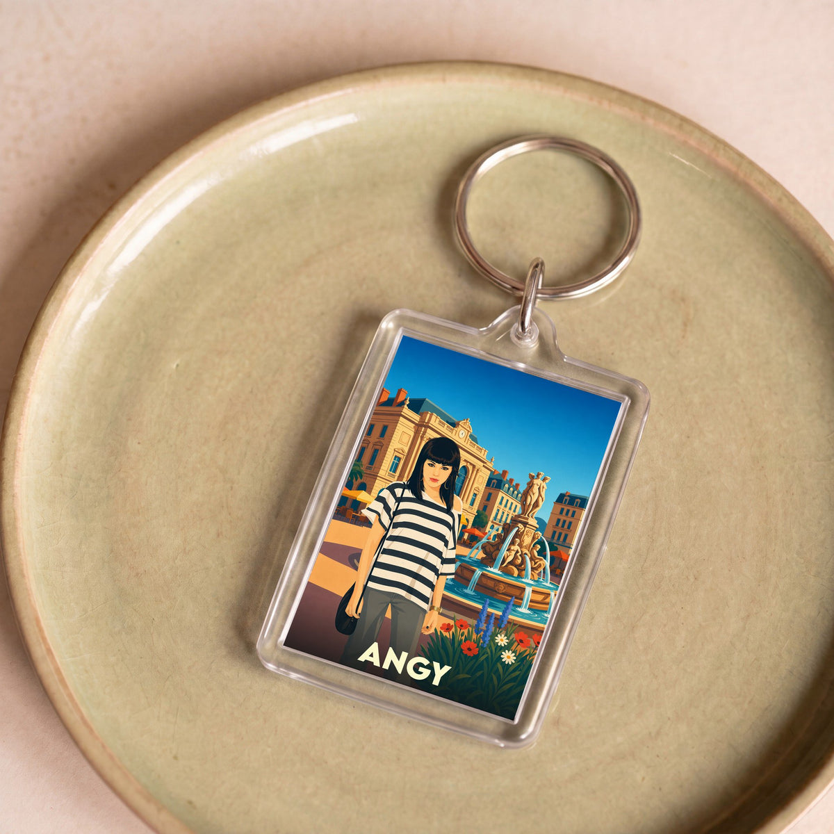 Porte-clés souvenir de la ville de Angy avec une illustration stylisée.
