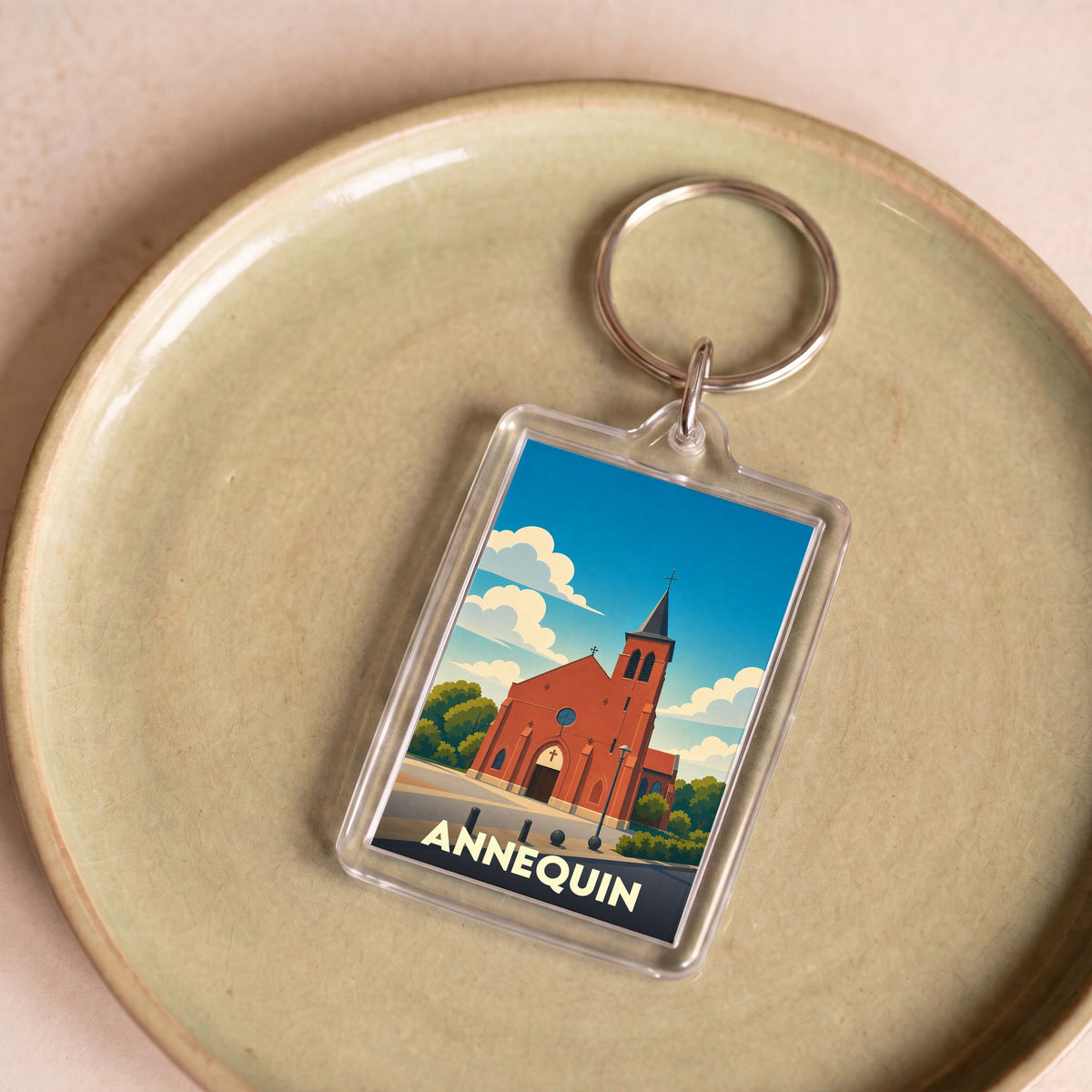 Porte-clés souvenir de la ville d'Annequin avec une illustration stylisée de son église.