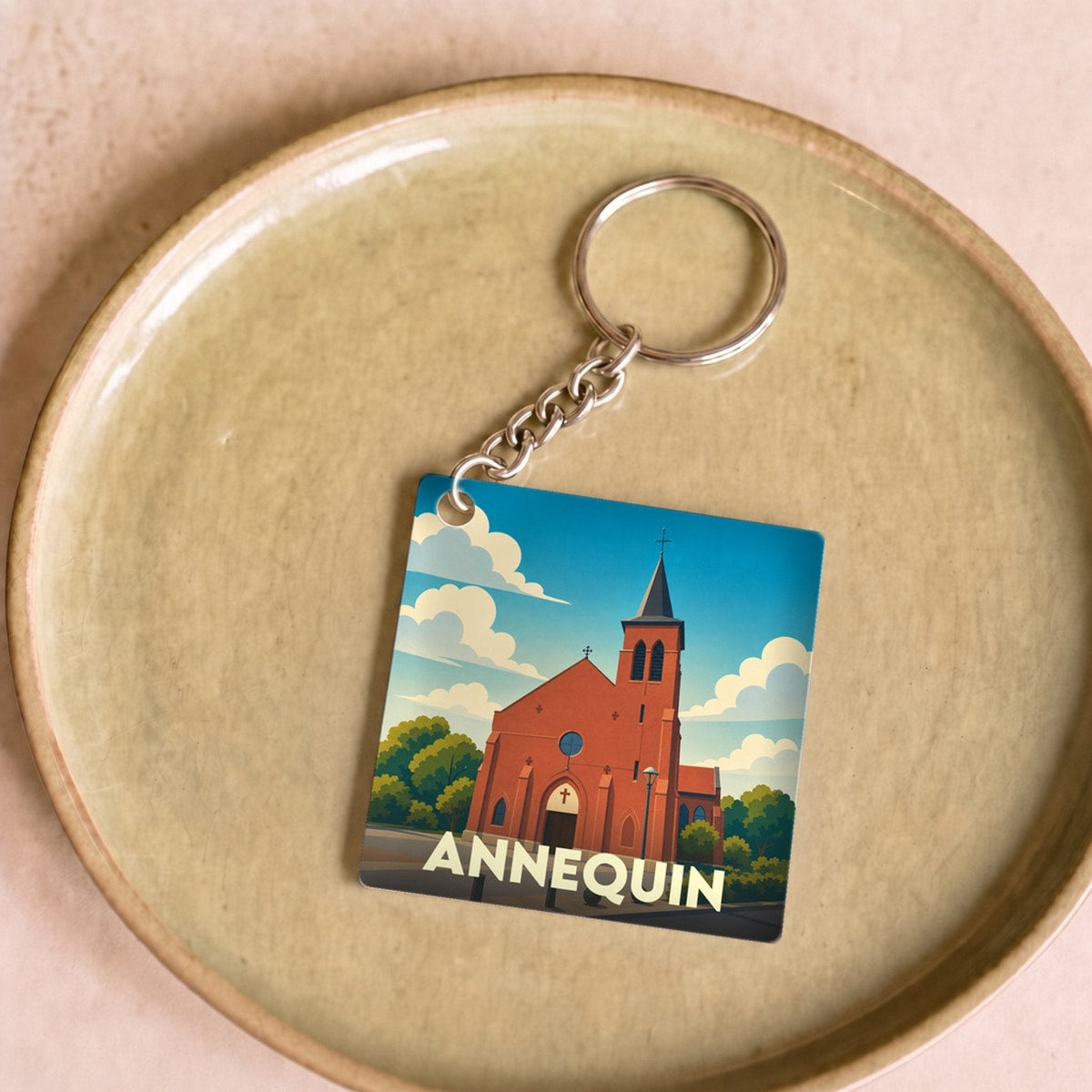 Porte-clés souvenir de la ville d'Annequin avec une illustration stylisée de son église.