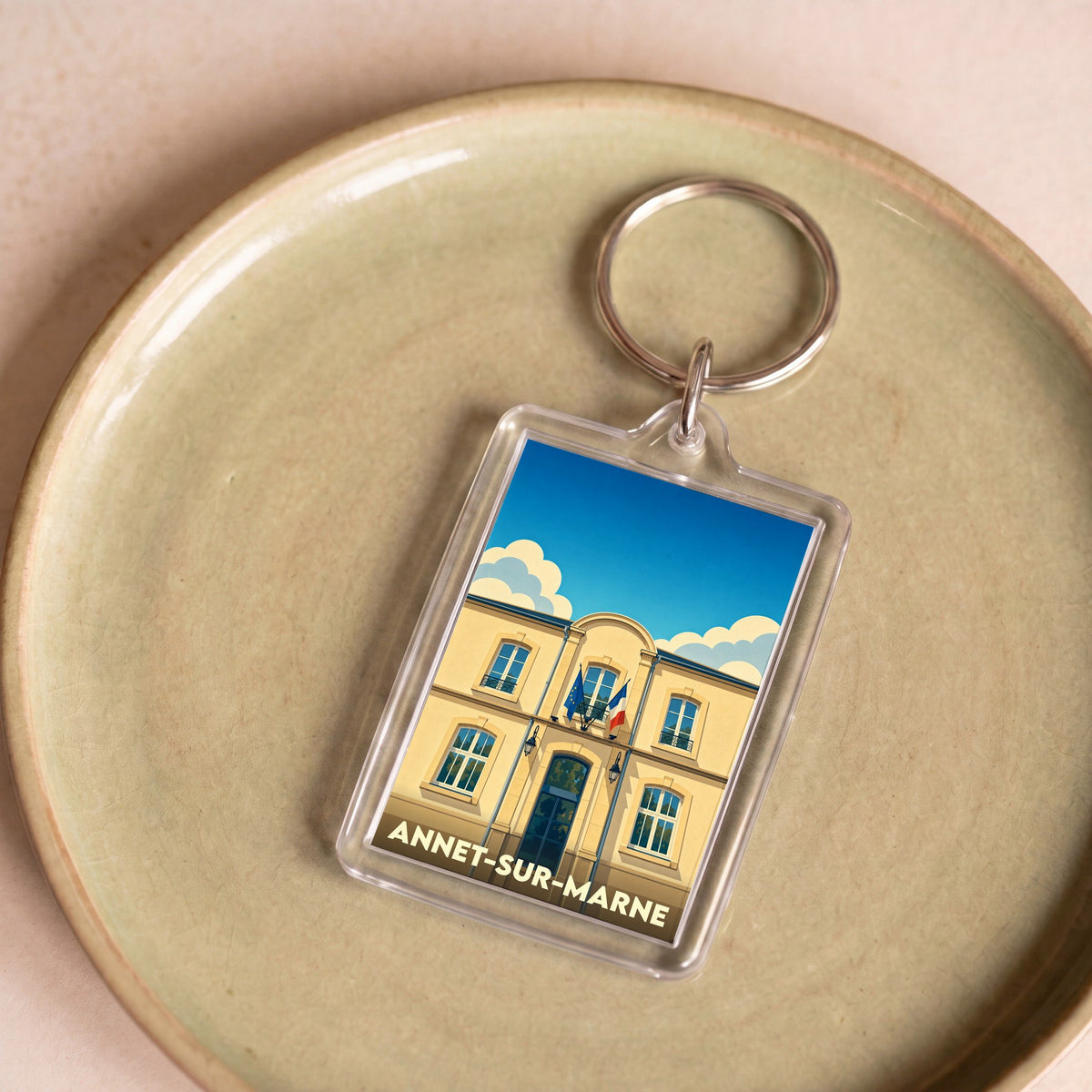 Porte-clés souvenir de la ville de Annet-sur-Marne avec une illustration stylisée de sa mairie.