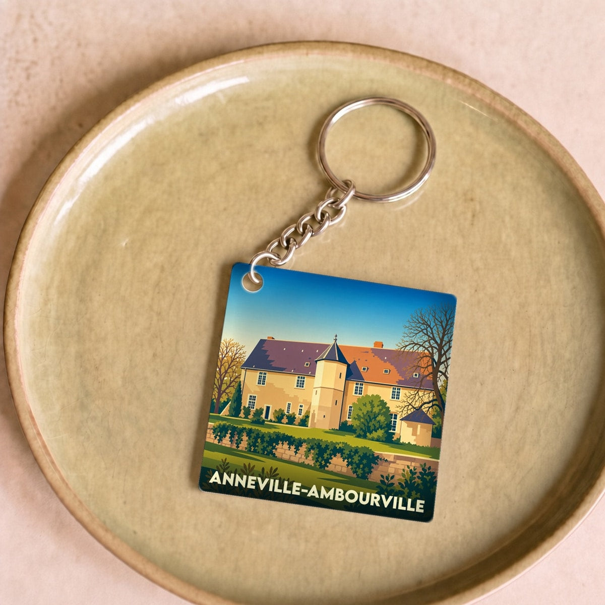 Porte-clés souvenir de la ville d'Anneville-Ambourville avec une illustration stylisée.