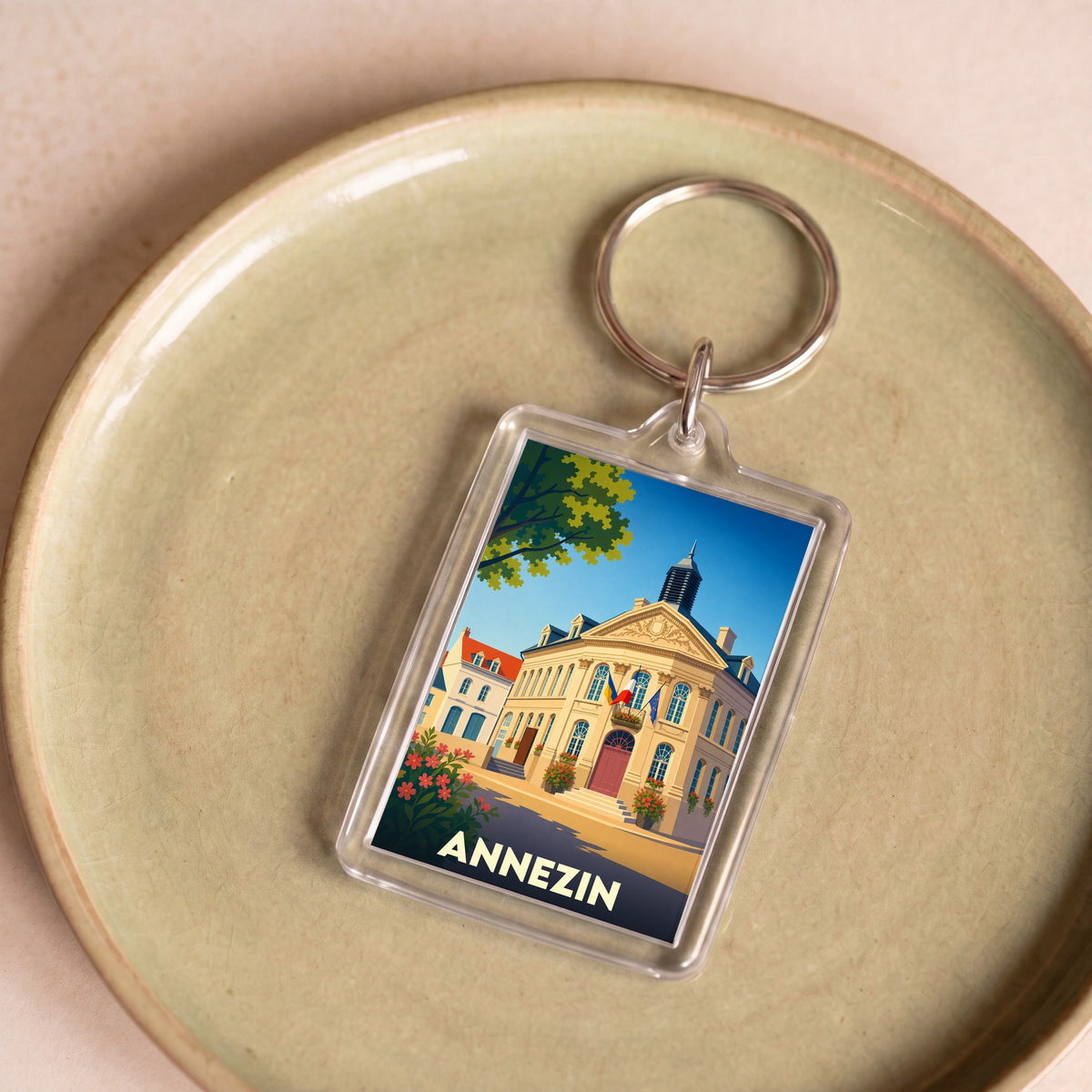 Porte-clés souvenir de la ville d'Annezin avec une illustration stylisée de l'hôtel de ville.