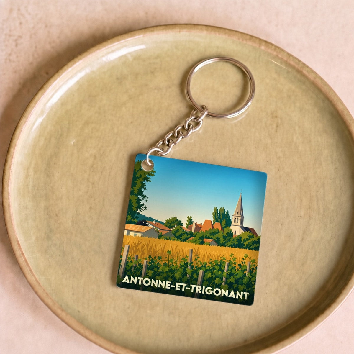 Porte-clés souvenir de la ville d'Antonne-et-Trigonant avec une illustration stylisée.