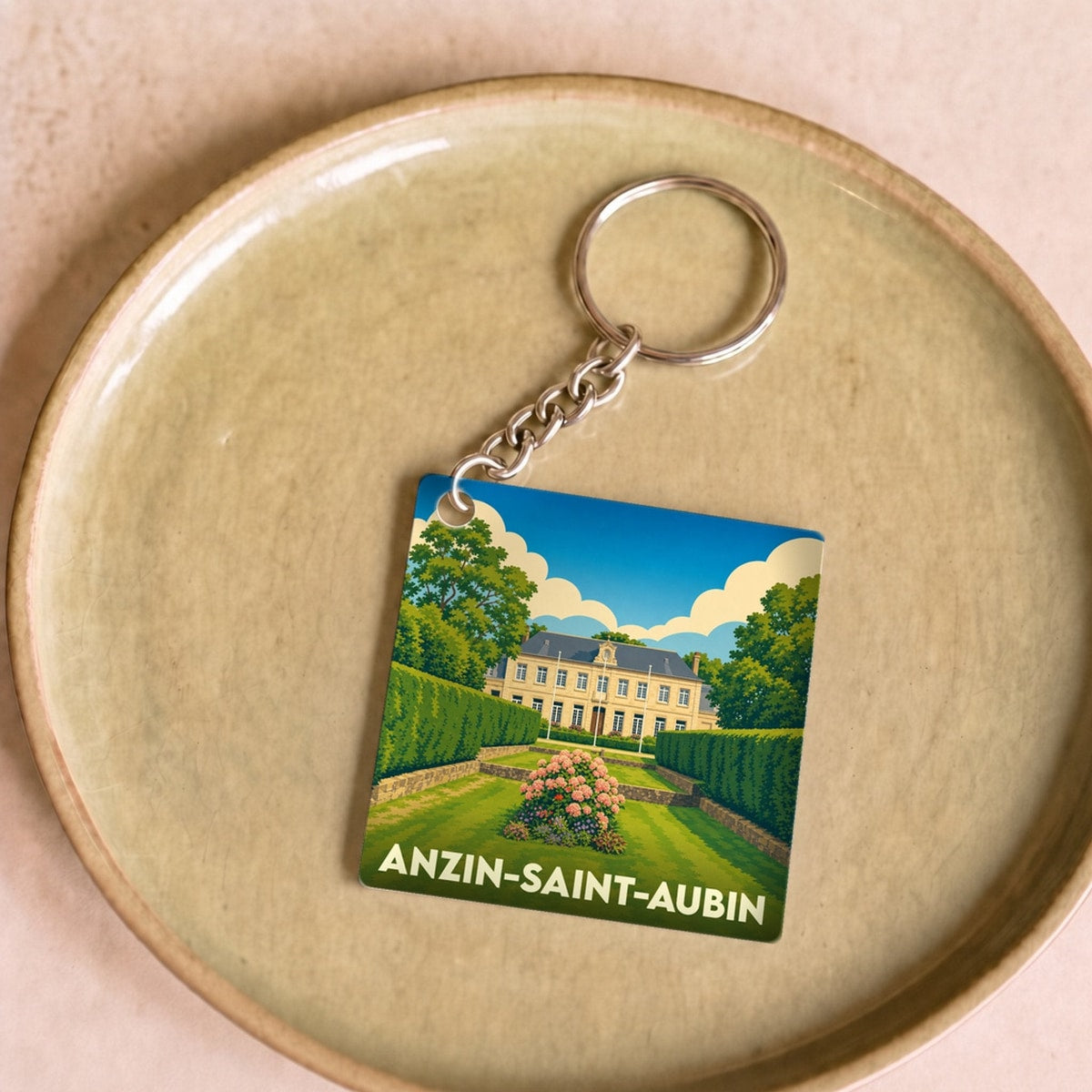Porte-clés souvenir de la ville d'Anzin-Saint-Aubin avec une illustration stylisée.