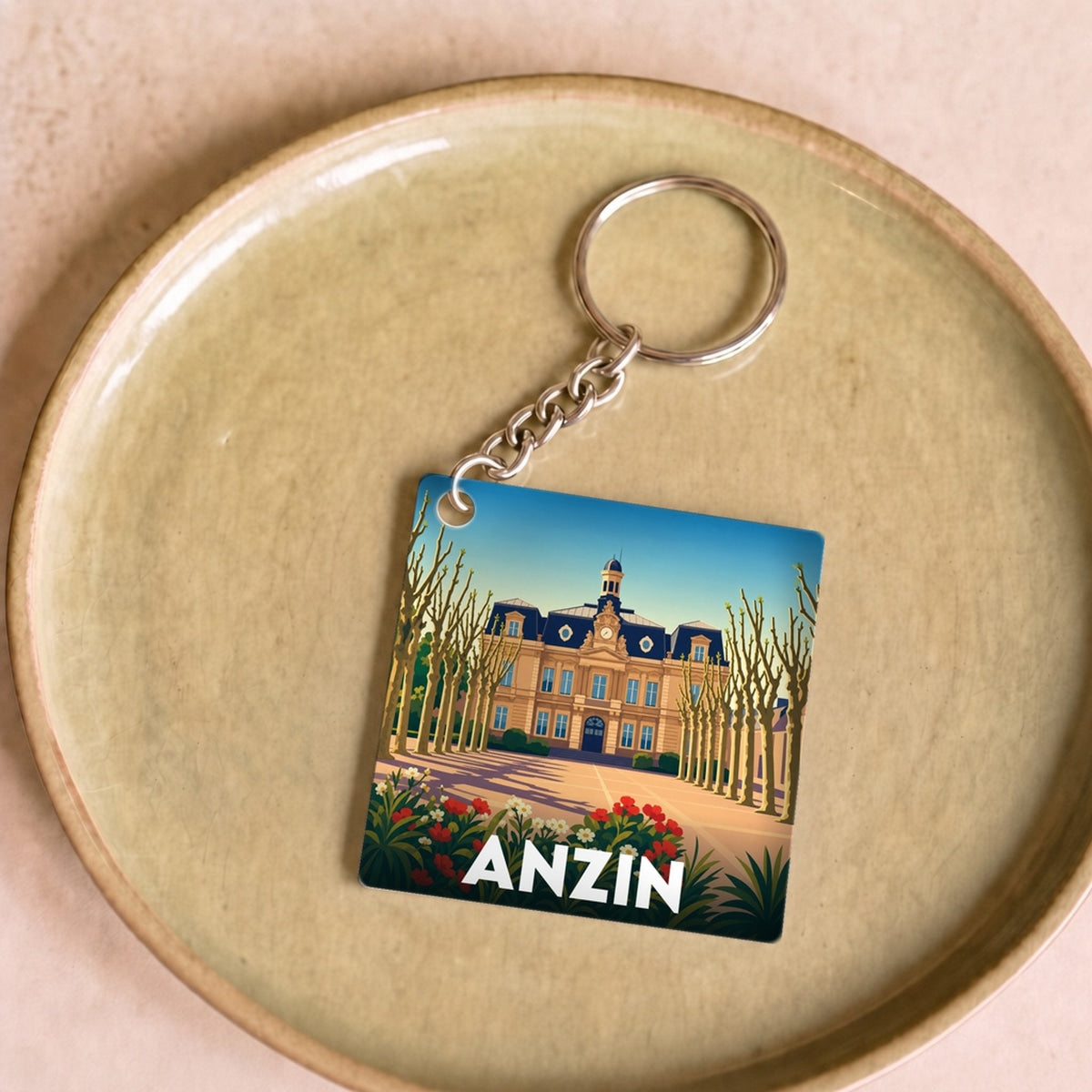 Porte-clés souvenir de la ville de Anzin avec une illustration stylisée.