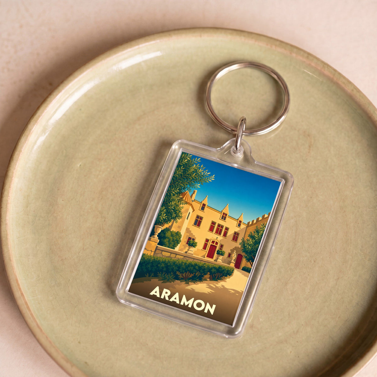 Porte-clés souvenir de la ville d'Aramon avec une illustration stylisée de son château.