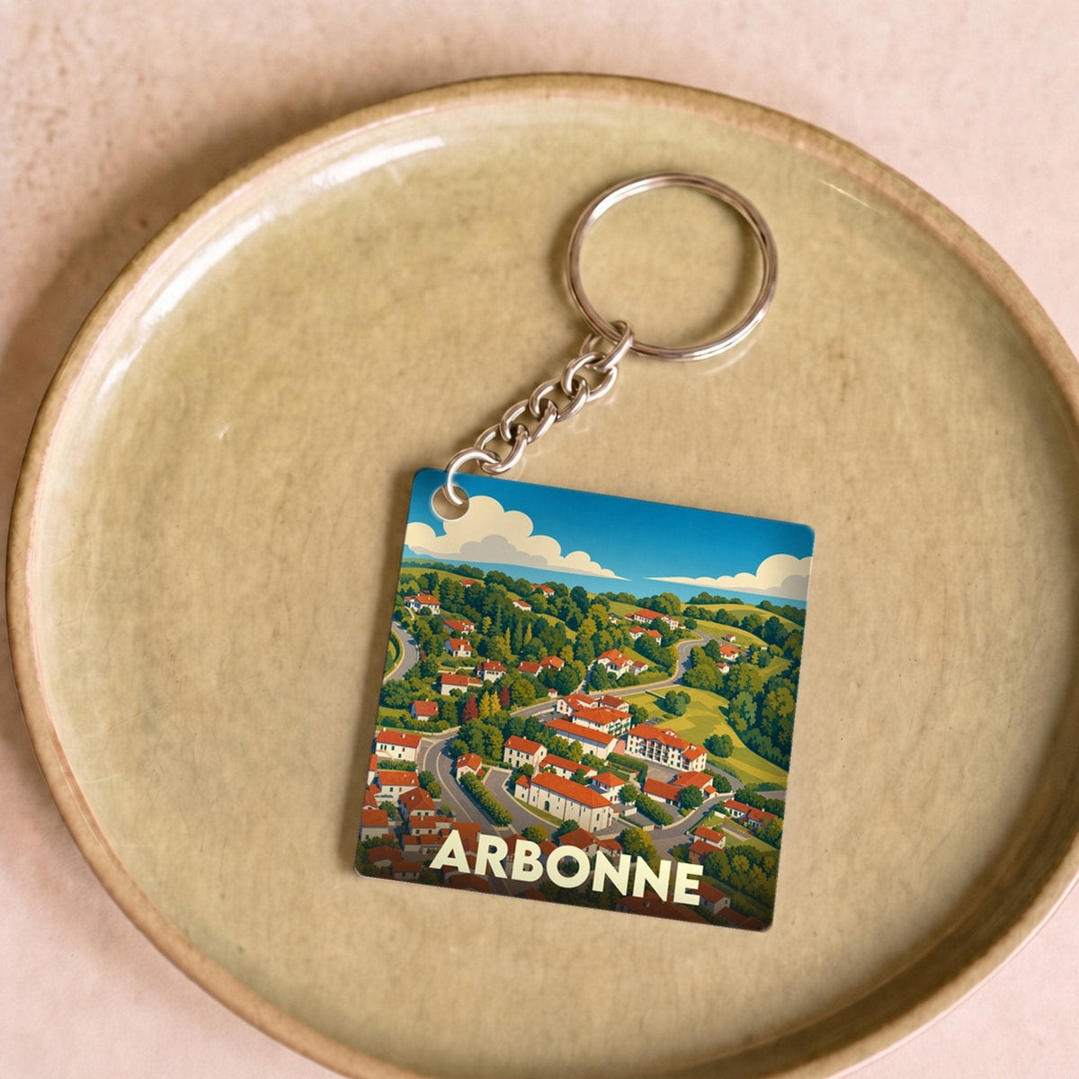 Porte-clés souvenir de la ville d'Arbonne avec une illustration stylisée.