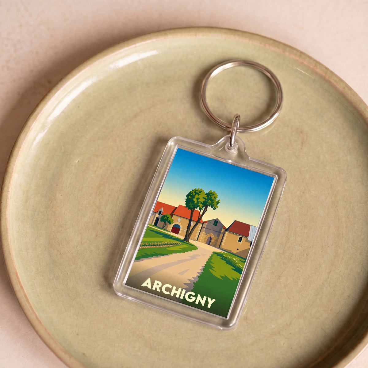 Porte-clés souvenir de la ville d'Archigny avec une illustration stylisée de son patrimoine architectural.
