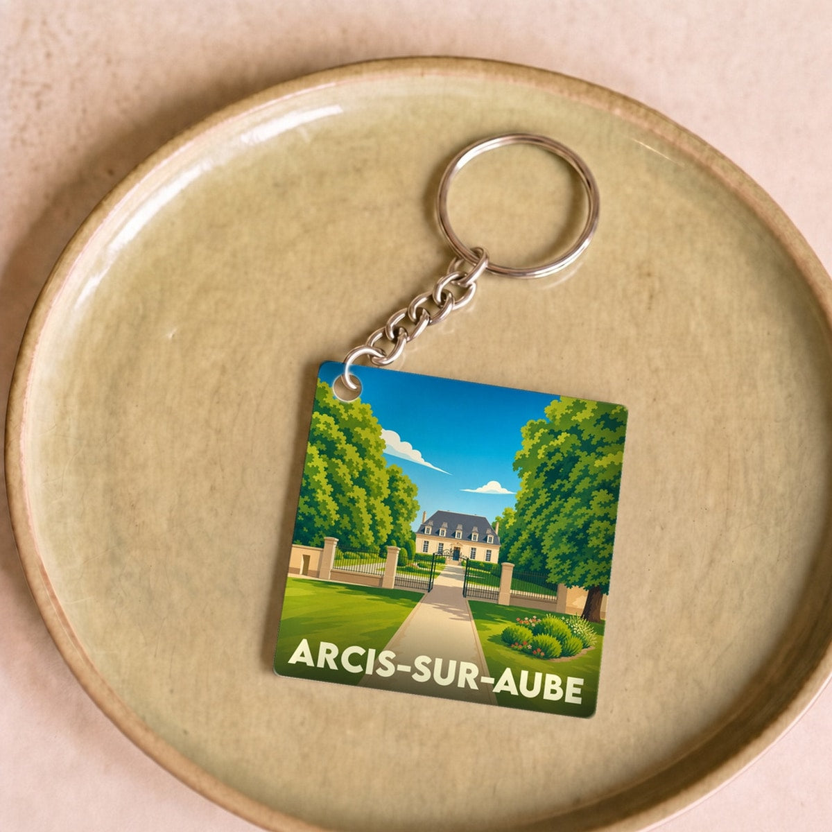 Porte-clés souvenir de la ville d'Arcis-sur-Aube avec une illustration stylisée.