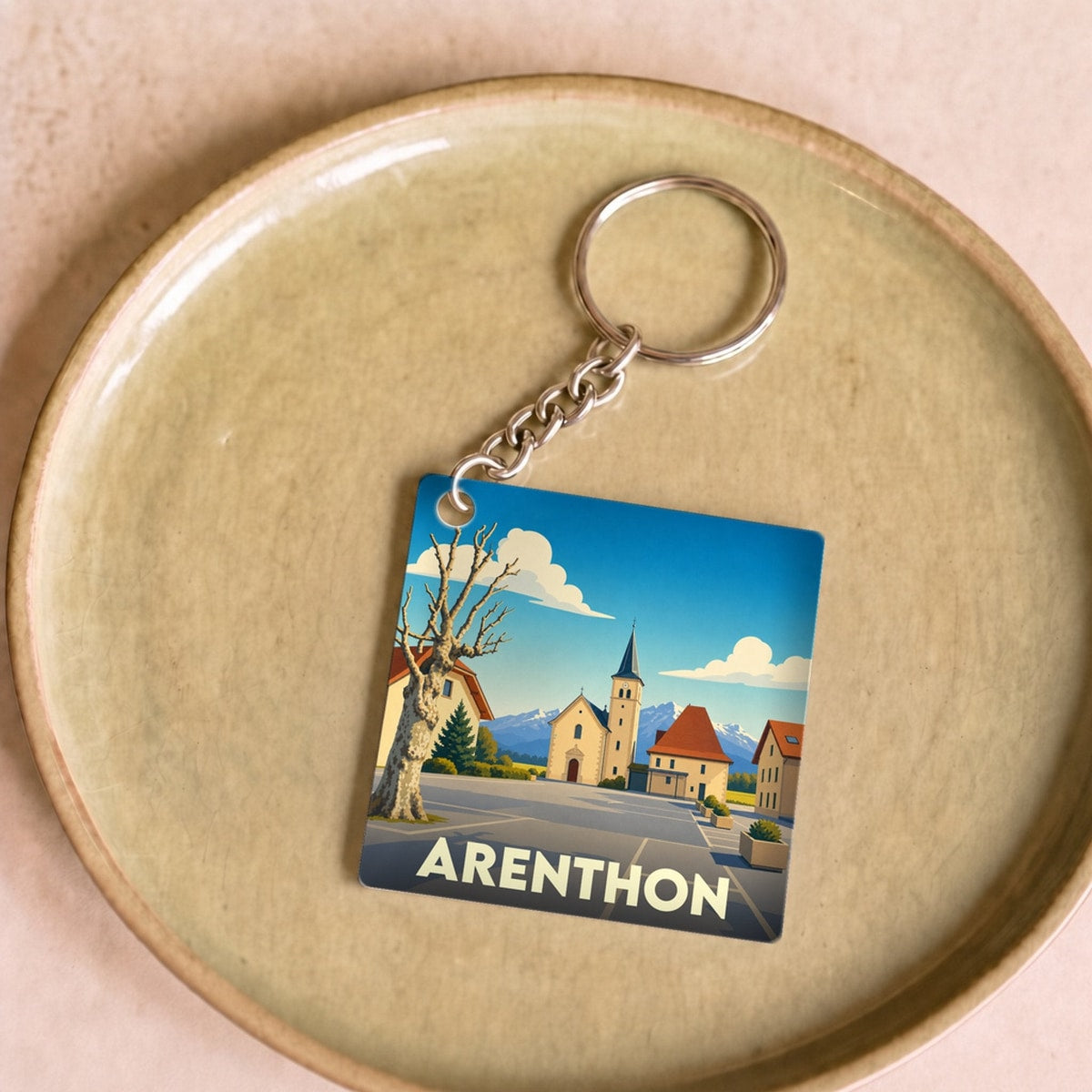 Porte-clés souvenir de la ville d'Arenthon avec une illustration stylisée.