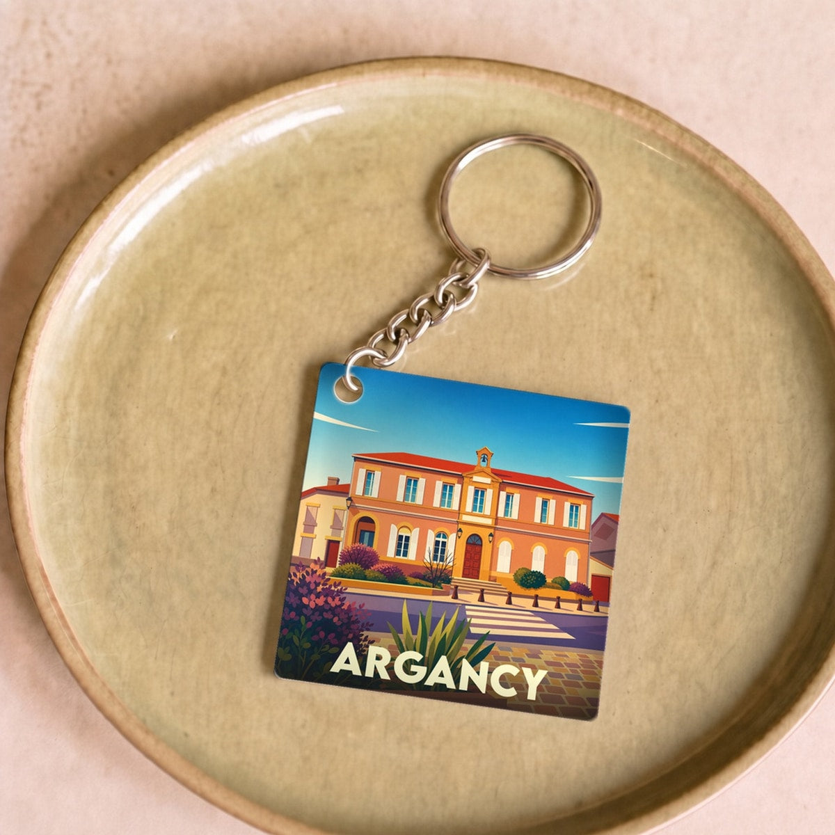 Porte-clés souvenir de la ville de Argancy avec une illustration stylisée de son architecture.