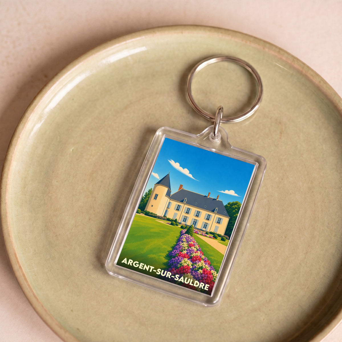 Porte-clés souvenir de la ville d'Argent-sur-Sauldre avec une illustration stylisée de son château.