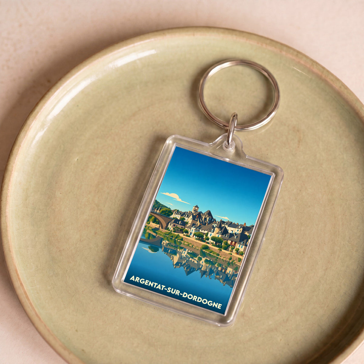 Porte-clés souvenir de la ville d'Argentat-sur-Dordogne avec une illustration stylisée.