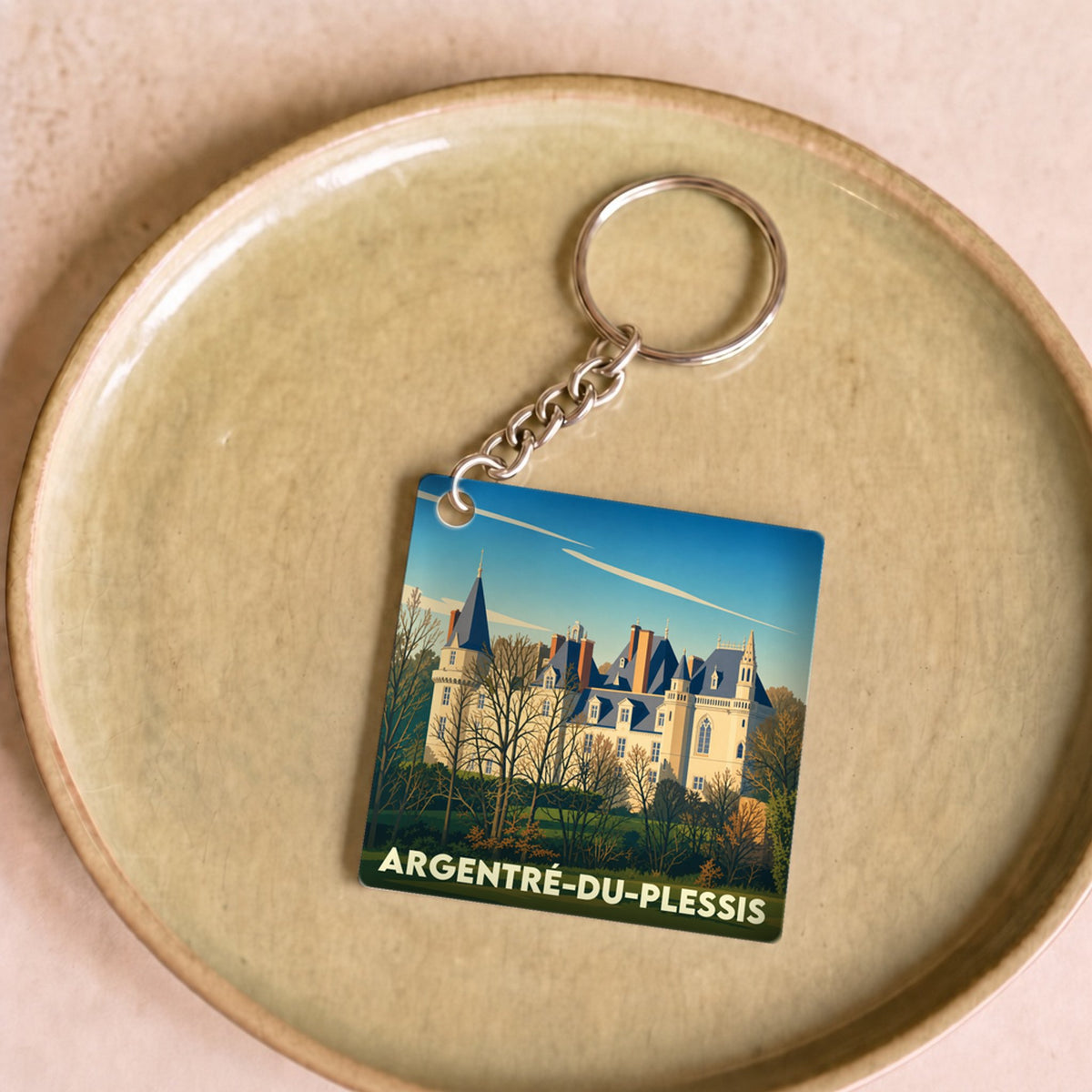 Porte-clés souvenir de la ville d'Argentré-du-Plessis avec une illustration stylisée de son château.