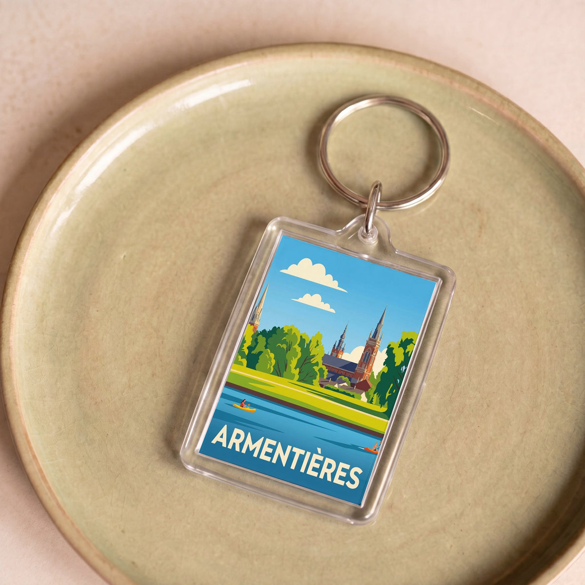 Porte-clés souvenir de la ville d'Armentières avec une illustration stylisée.