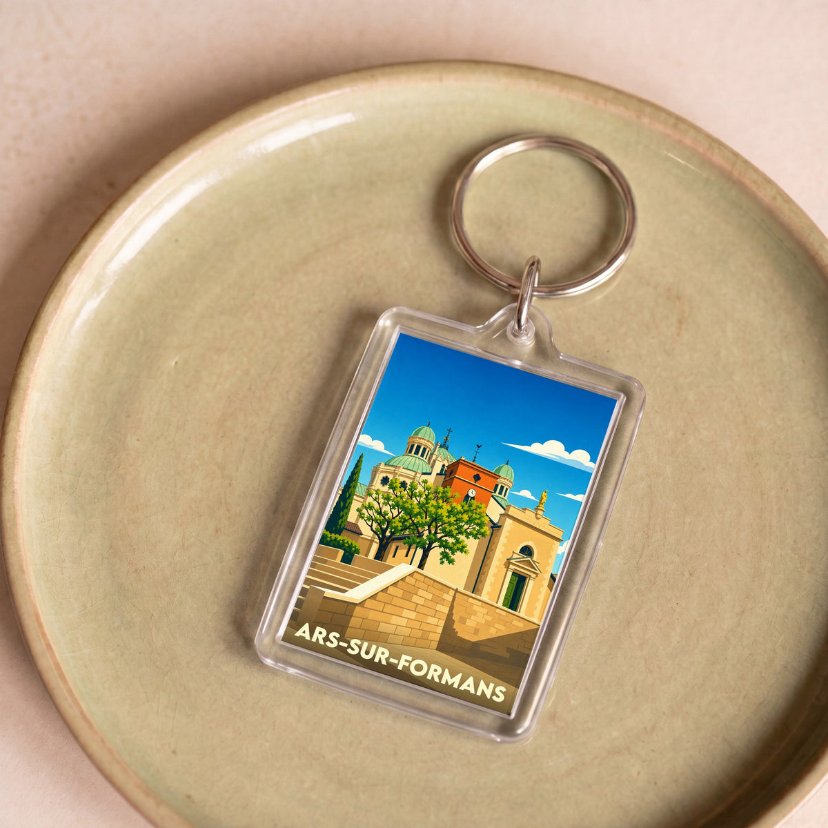 Porte-clés souvenir de la ville de Ars-sur-Formans avec une illustration stylisée.