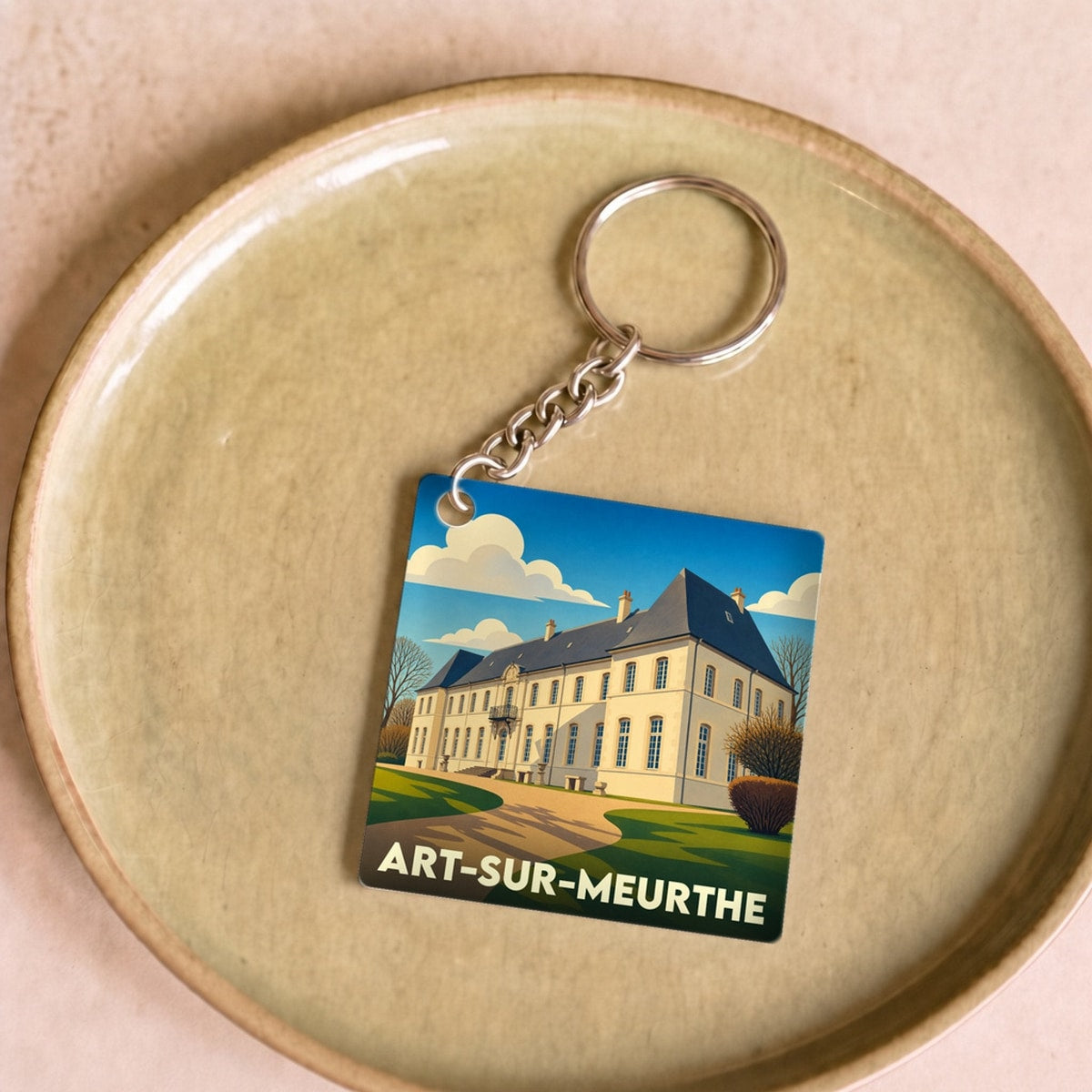 Porte-clés souvenir de la ville de Art-sur-Meurthe avec une illustration stylisée de son château.