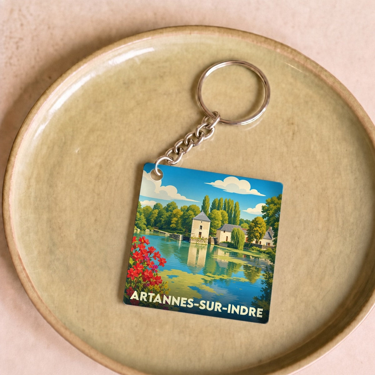 Porte-clés souvenir de la ville d'Artannes-sur-Indre avec une illustration stylisée des bords de l'Indre.