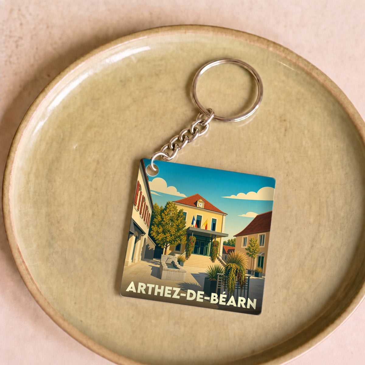 Porte-clés souvenir de la ville de Arthez-de-Béarn avec une illustration stylisée.