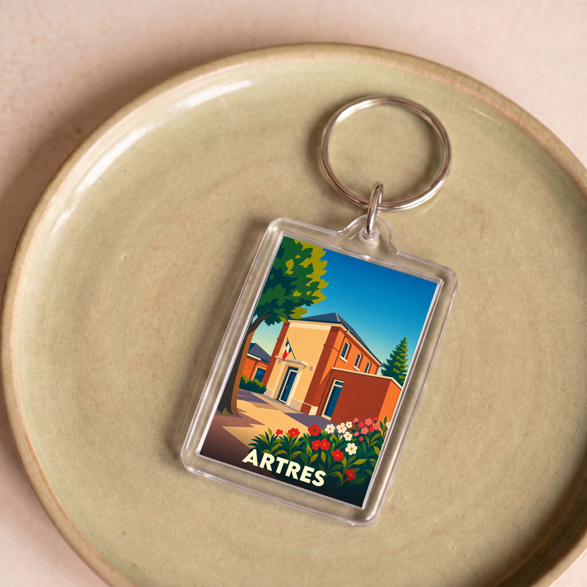 Porte-clés souvenir de la ville de Artres avec une illustration stylisée et colorée.