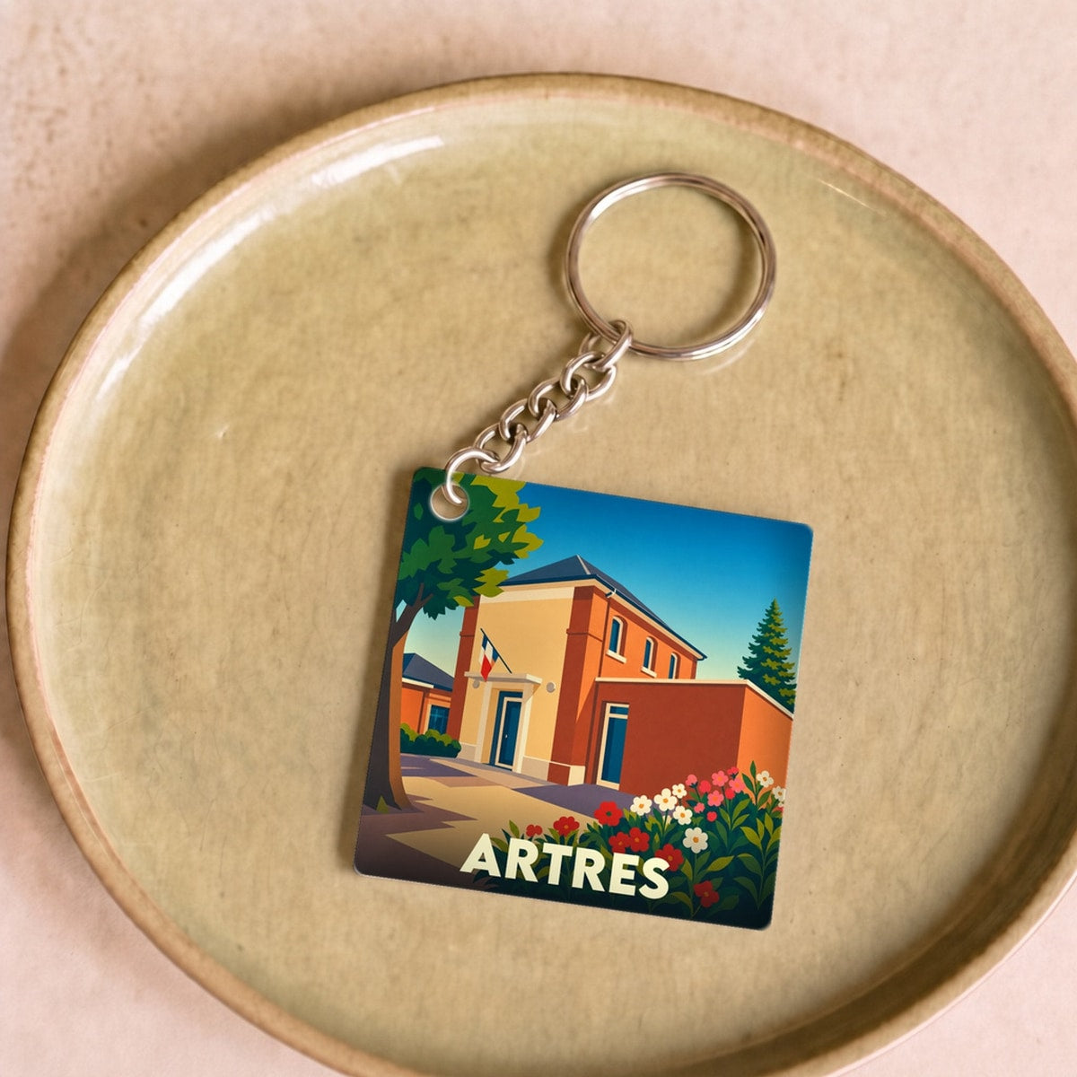 Porte-clés souvenir de la ville de Artres avec une illustration stylisée et colorée.