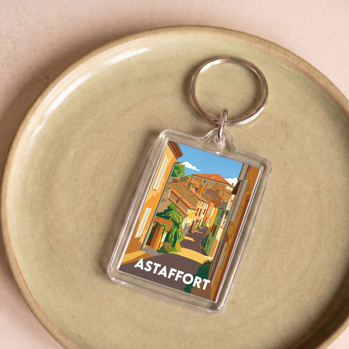 Porte-clés souvenir de la ville d'Astaffort avec une illustration stylisée.