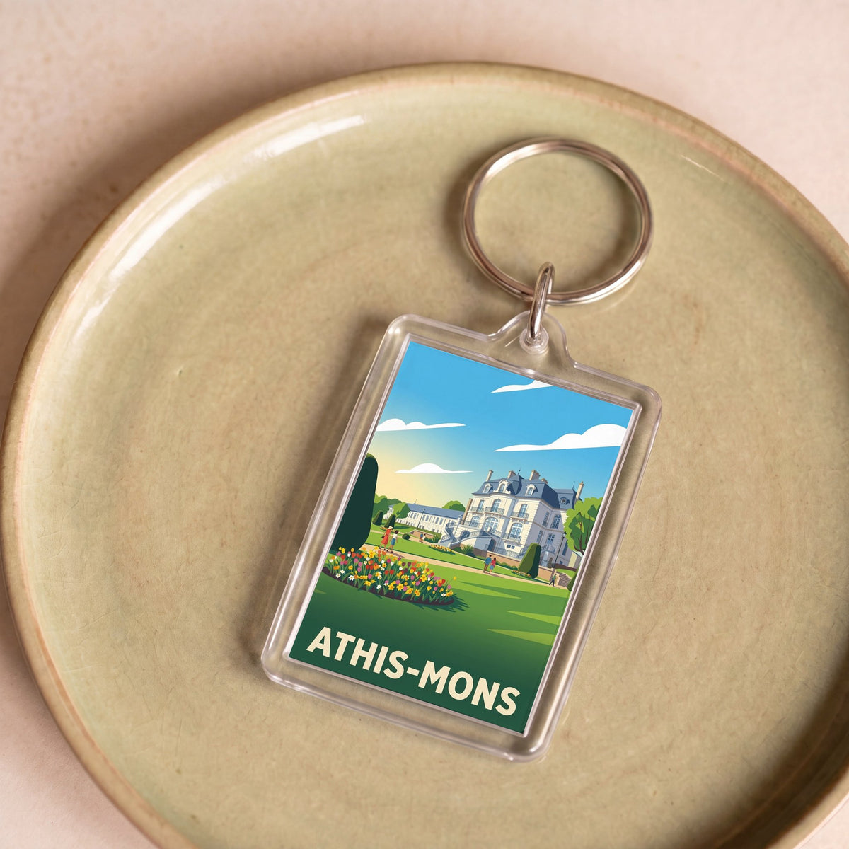 Porte-clés souvenir de la ville d'Athis-Mons avec une illustration stylisée.