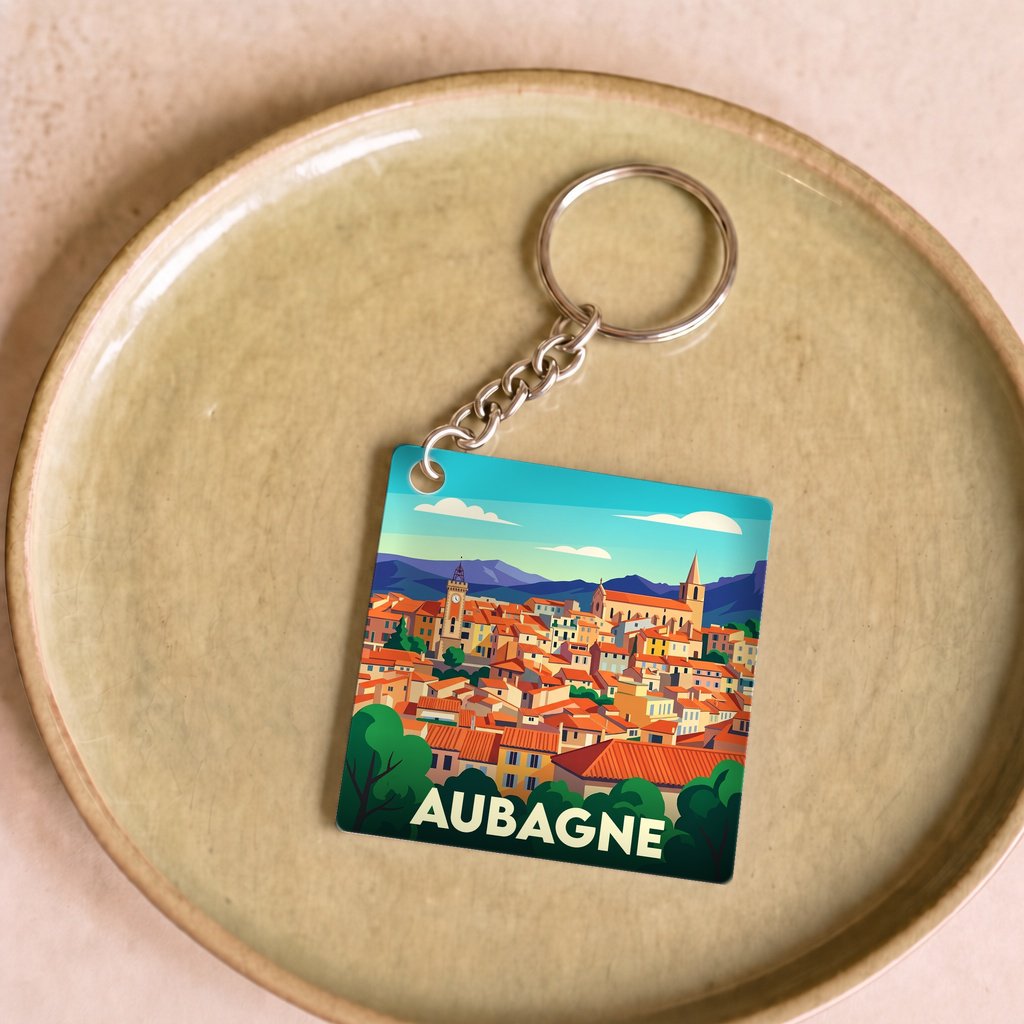 Porte-clés souvenir de la ville d'Aubagne avec une illustration stylisée.