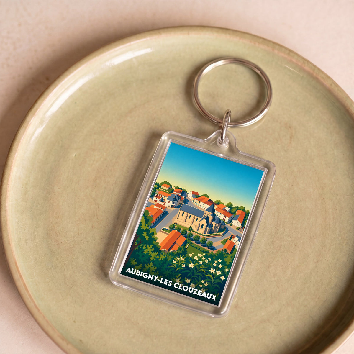 Porte-clés souvenir de la ville de Aubigny-Les Clouzeaux avec une illustration stylisée.