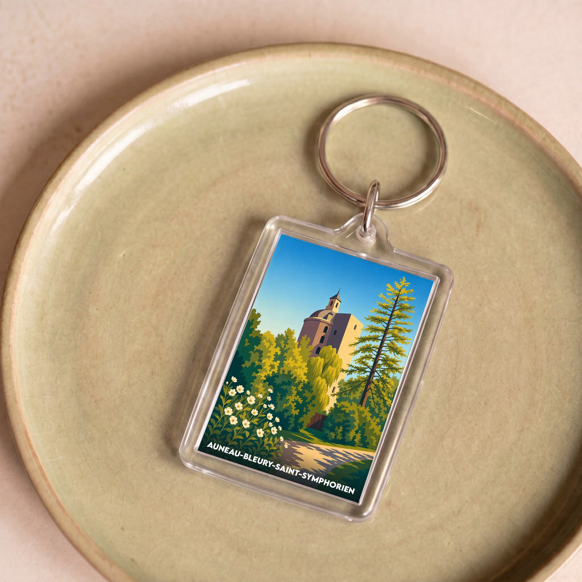 Porte-clés souvenir de la ville d'Auneau-Bleury-Saint-Symphorien avec une illustration stylisée de son château.