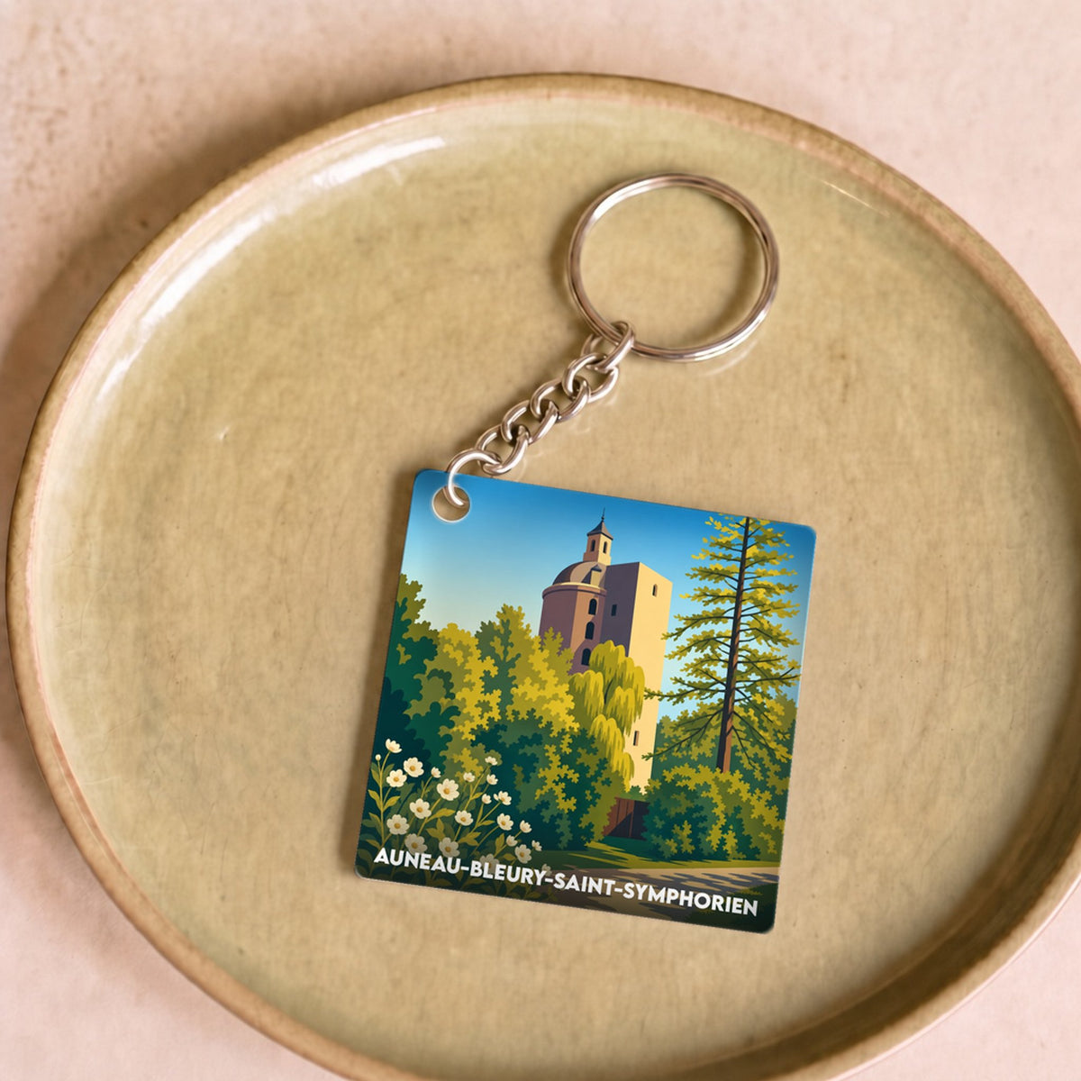 Porte-clés souvenir de la ville d'Auneau-Bleury-Saint-Symphorien avec une illustration stylisée de son château.
