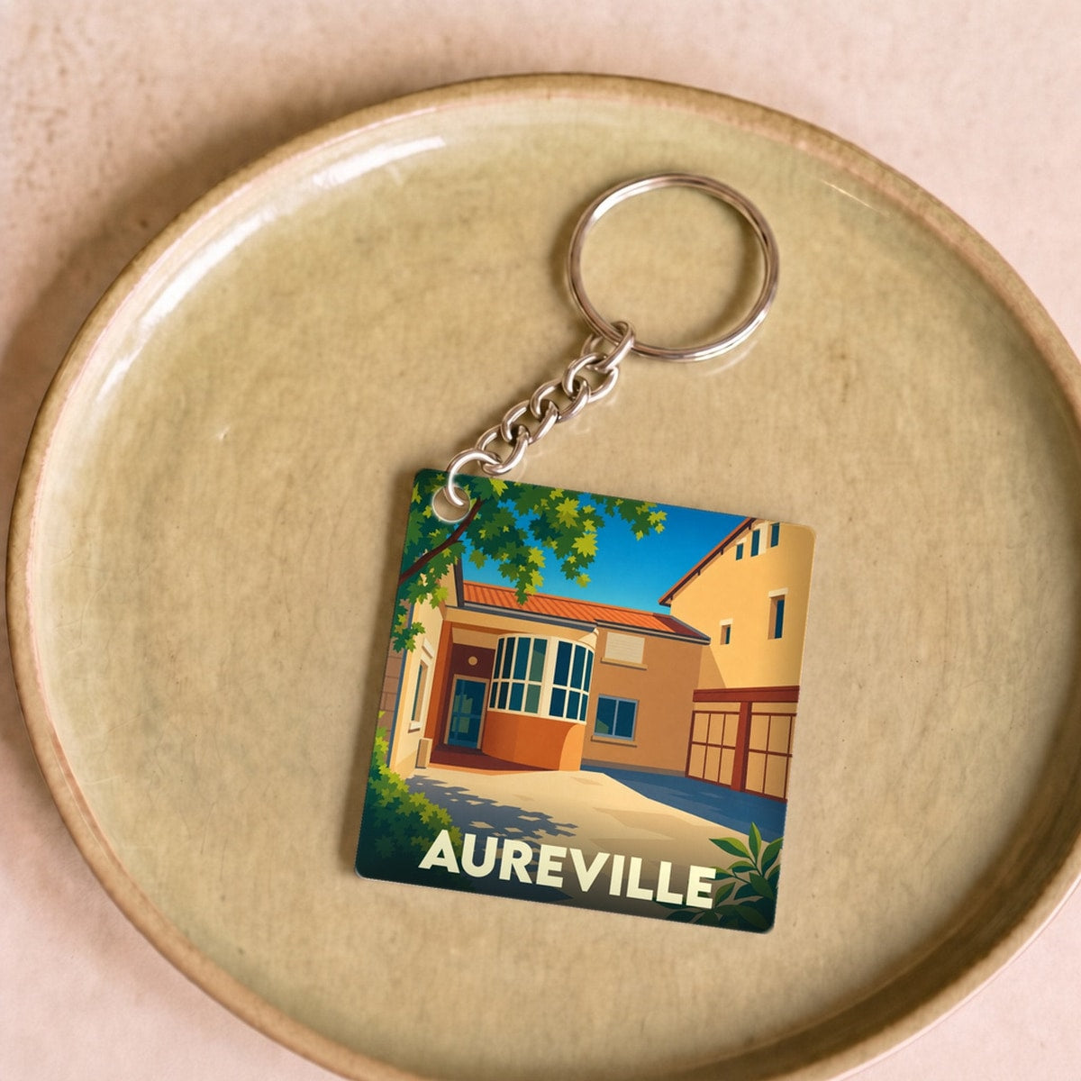 Porte-clés souvenir de la ville de Aureville avec une illustration stylisée et colorée.