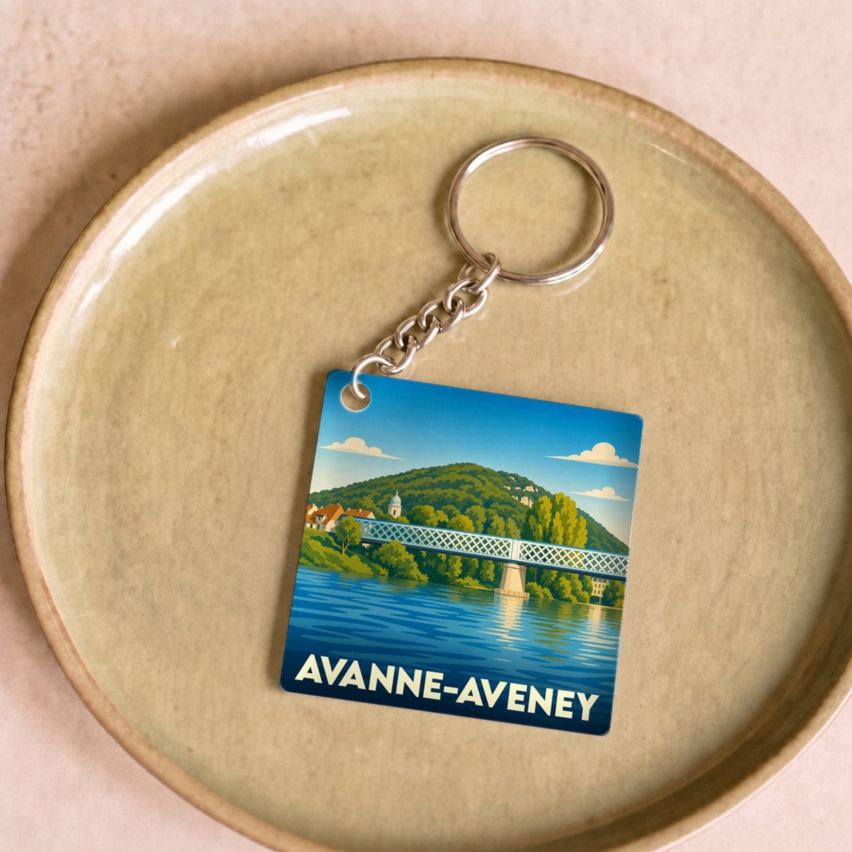 Porte-clés souvenir de la ville d'Avanne-Aveney avec une illustration stylisée de son pont sur le Doubs.