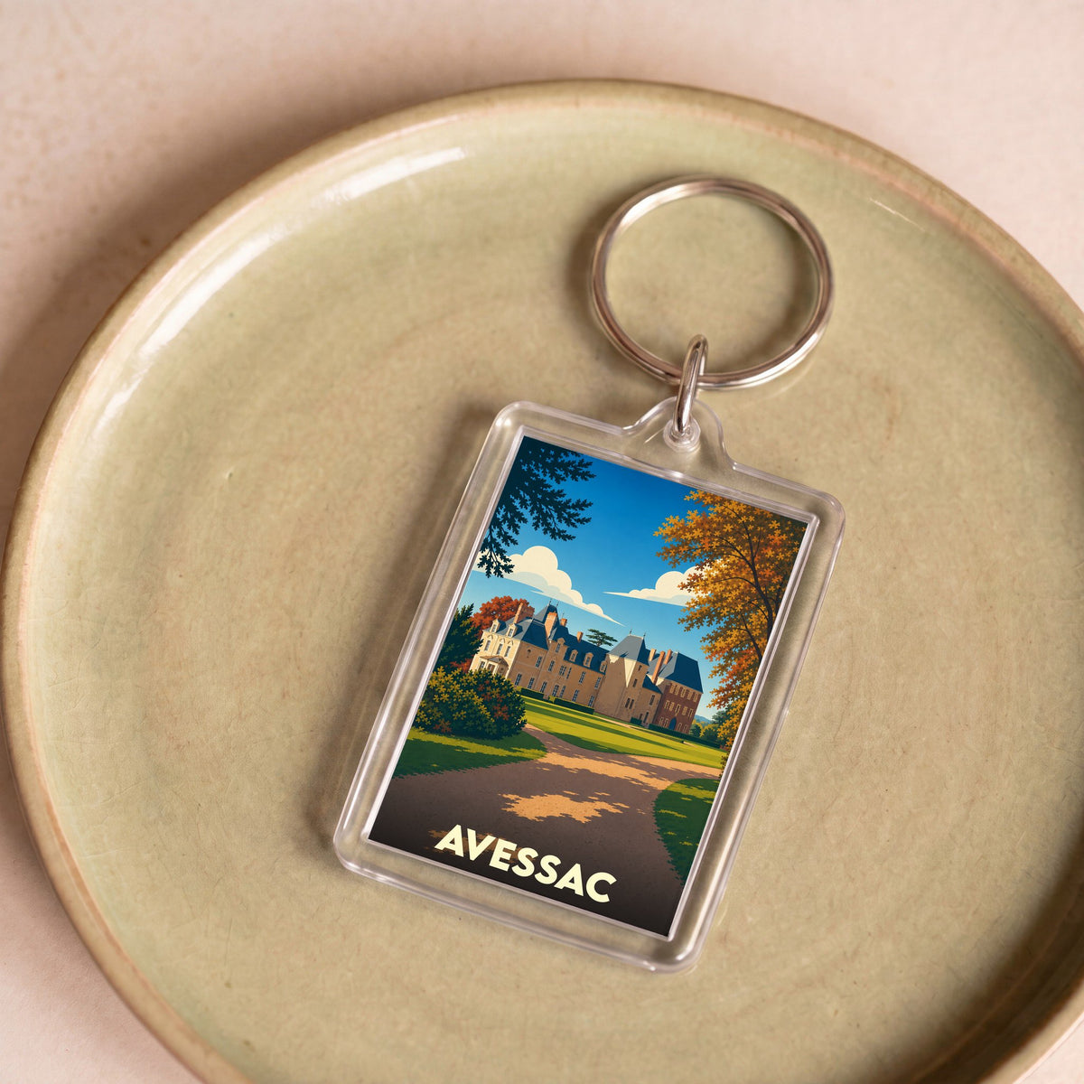 Porte-clés souvenir de la ville d'Avessac avec une illustration stylisée d'un château.