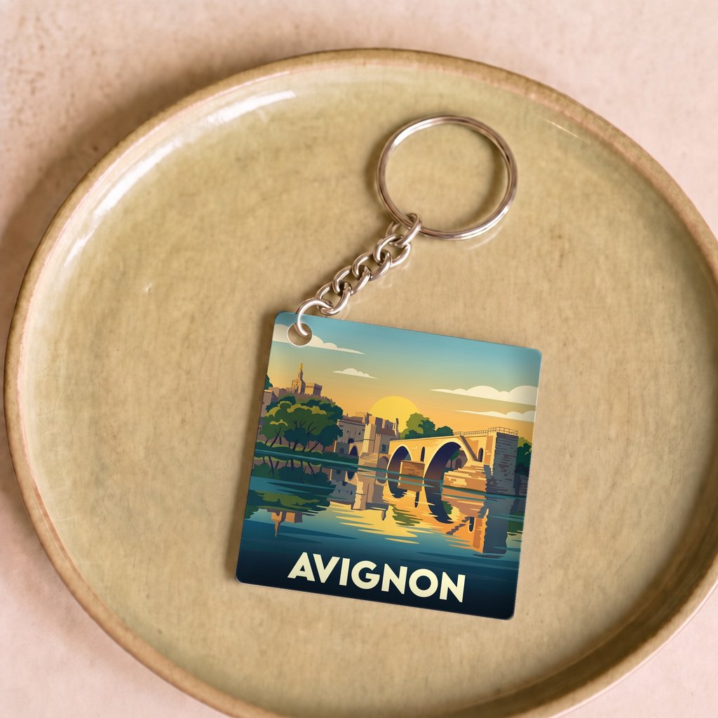 Porte-clés souvenir de la ville d'Avignon présentant une illustration stylisée et colorée.