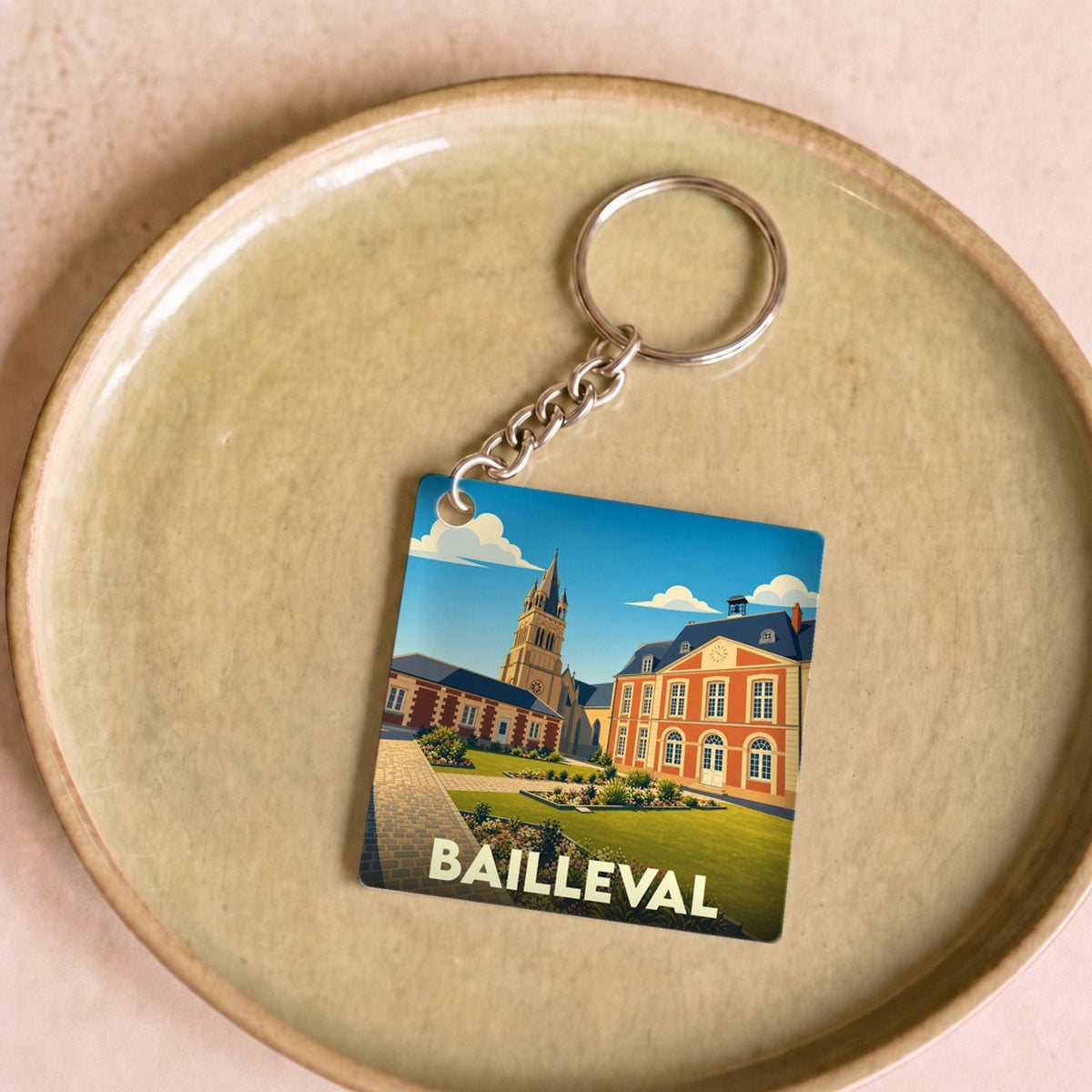 Porte-clés souvenir de la ville de Bailleval avec une illustration stylisée.