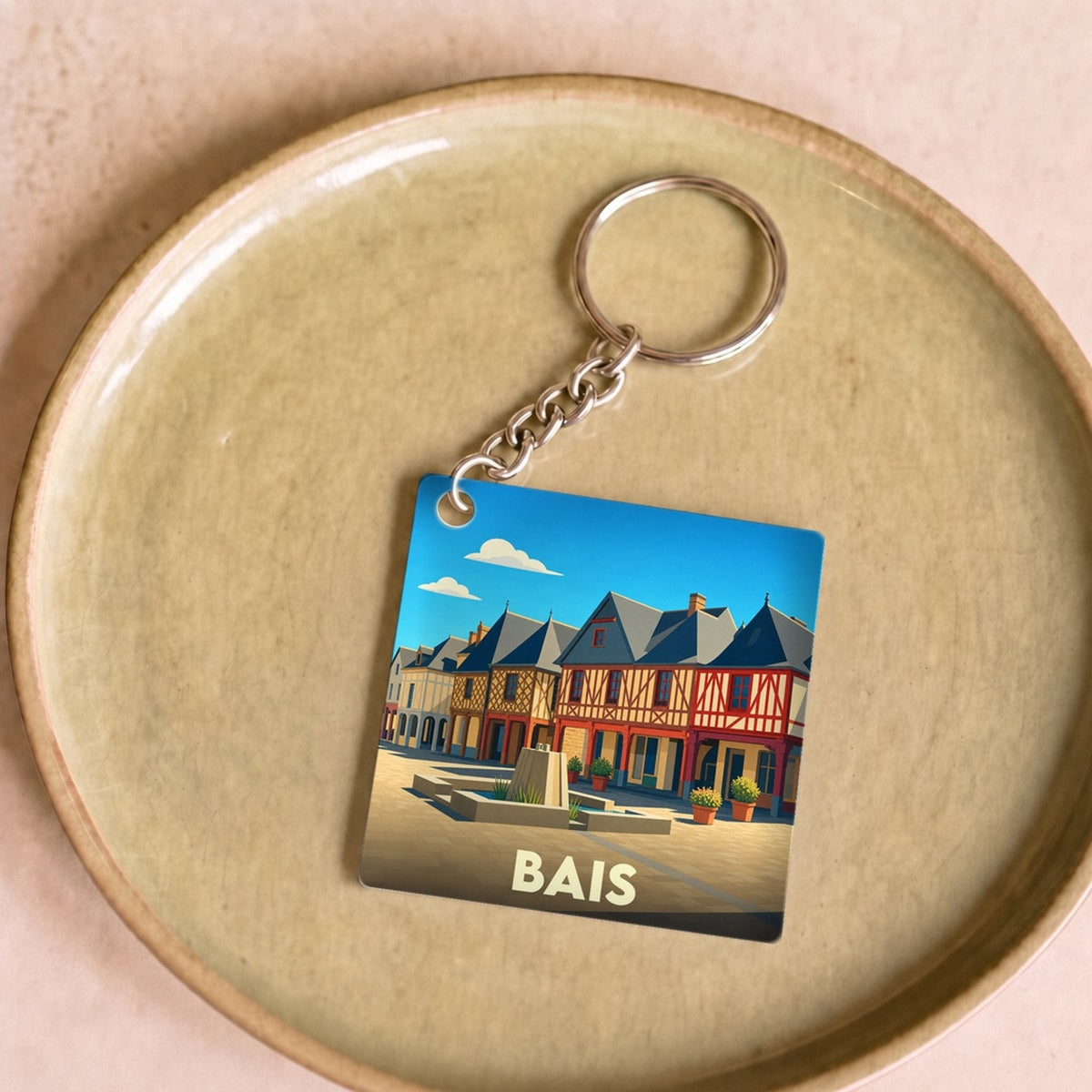 Porte-clés souvenir de la ville de Bais avec une illustration stylisée.