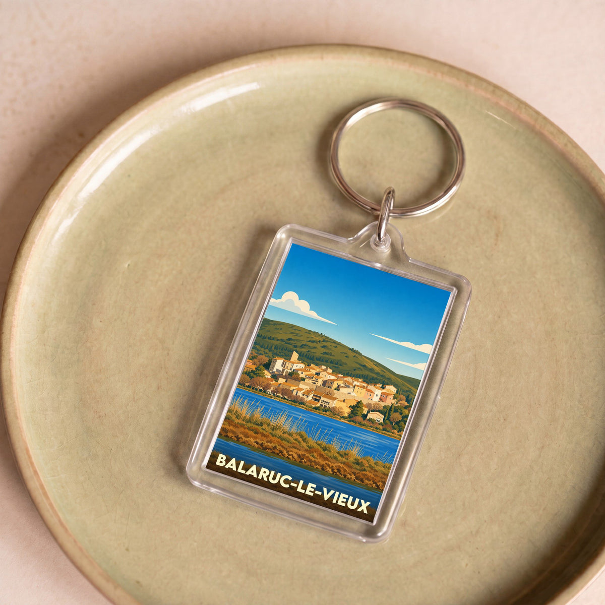 Porte-clés souvenir de la ville de Balaruc-le-Vieux avec une illustration stylisée.