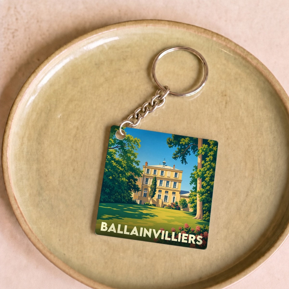Porte-clés souvenir de la ville de Ballainvilliers avec une illustration stylisée de son château.