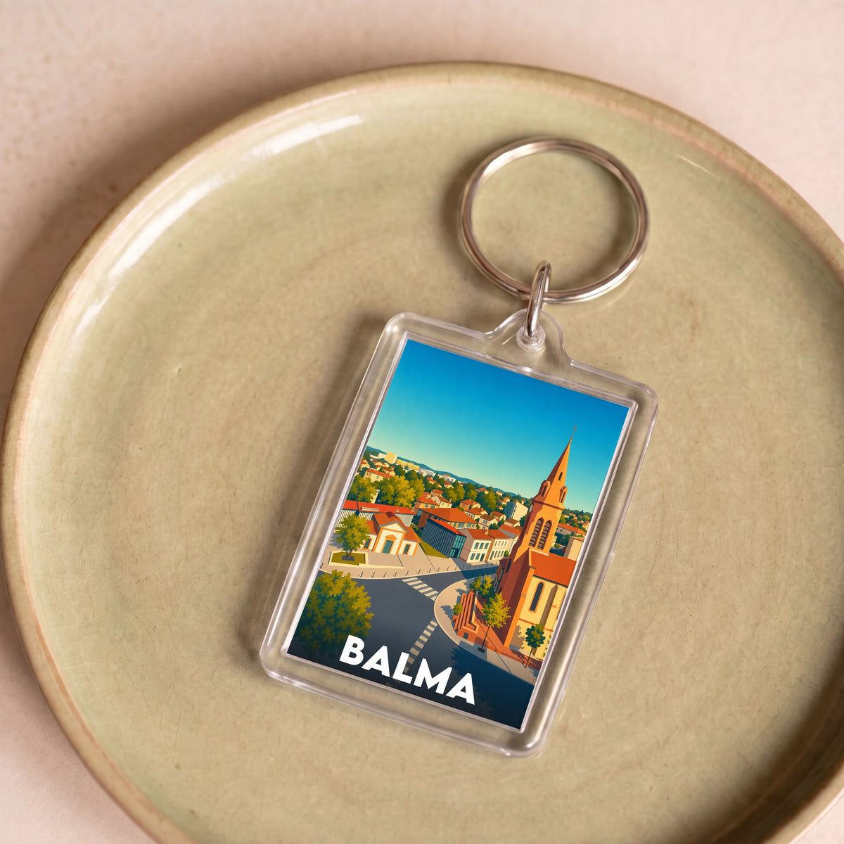 Porte-clés souvenir de la ville de Balma avec une illustration stylisée.
